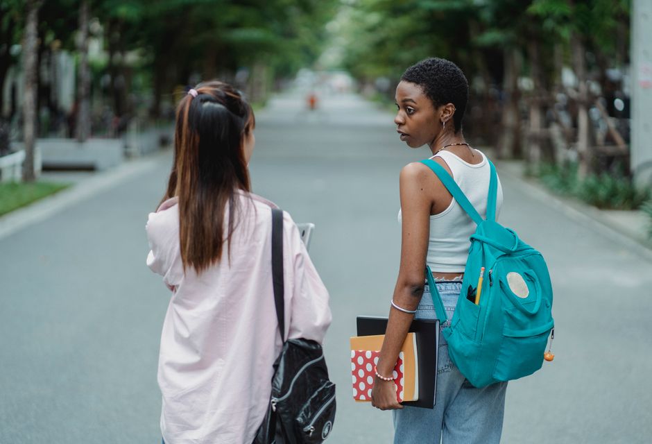 Modern campus building with students walking
