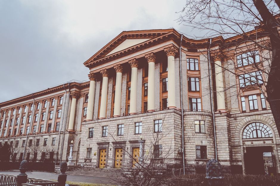 TUM campus building with modern architecture and students walking